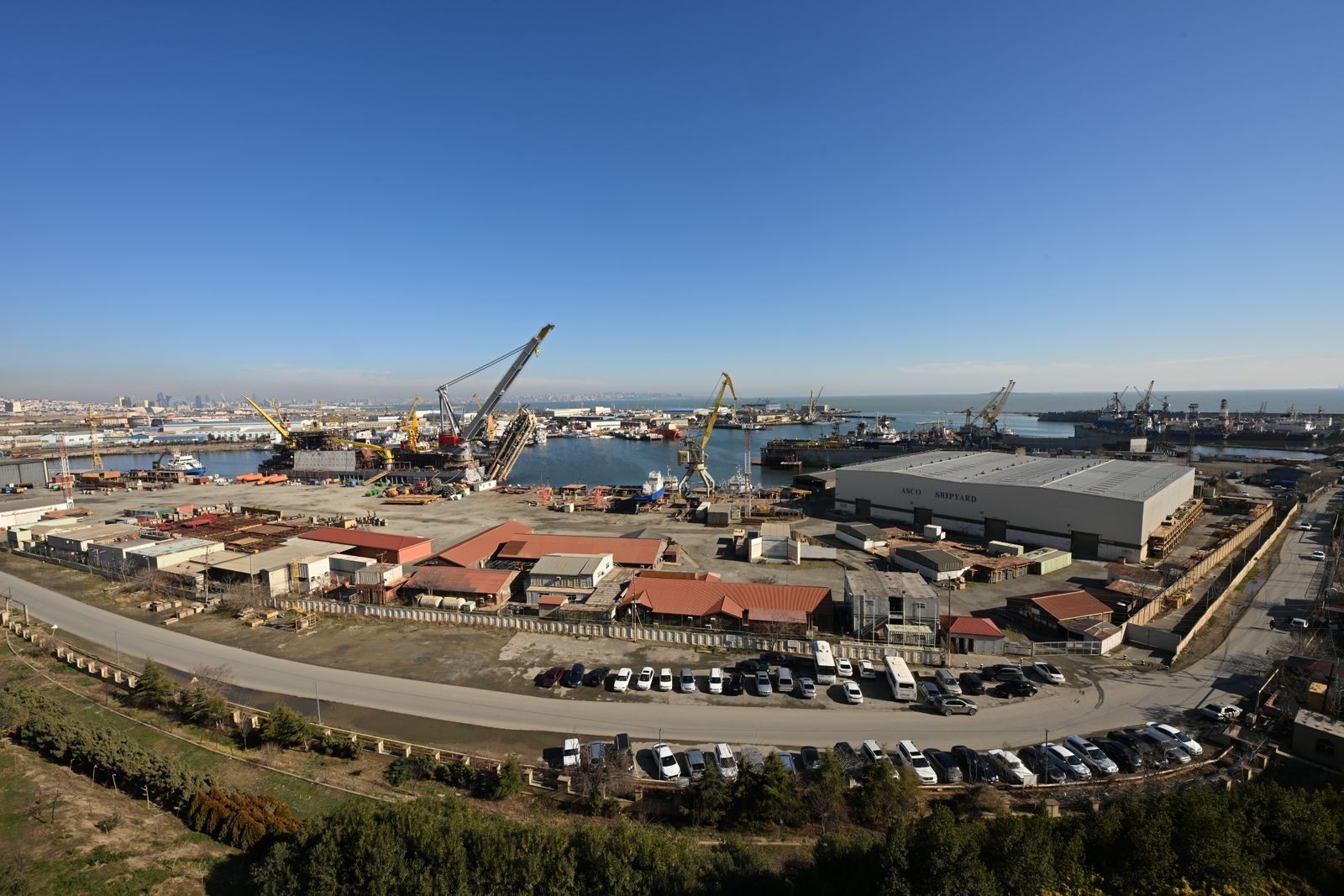 Aerial view of a busy shipyard and harbour, where new cruise ships for 2027 take shape