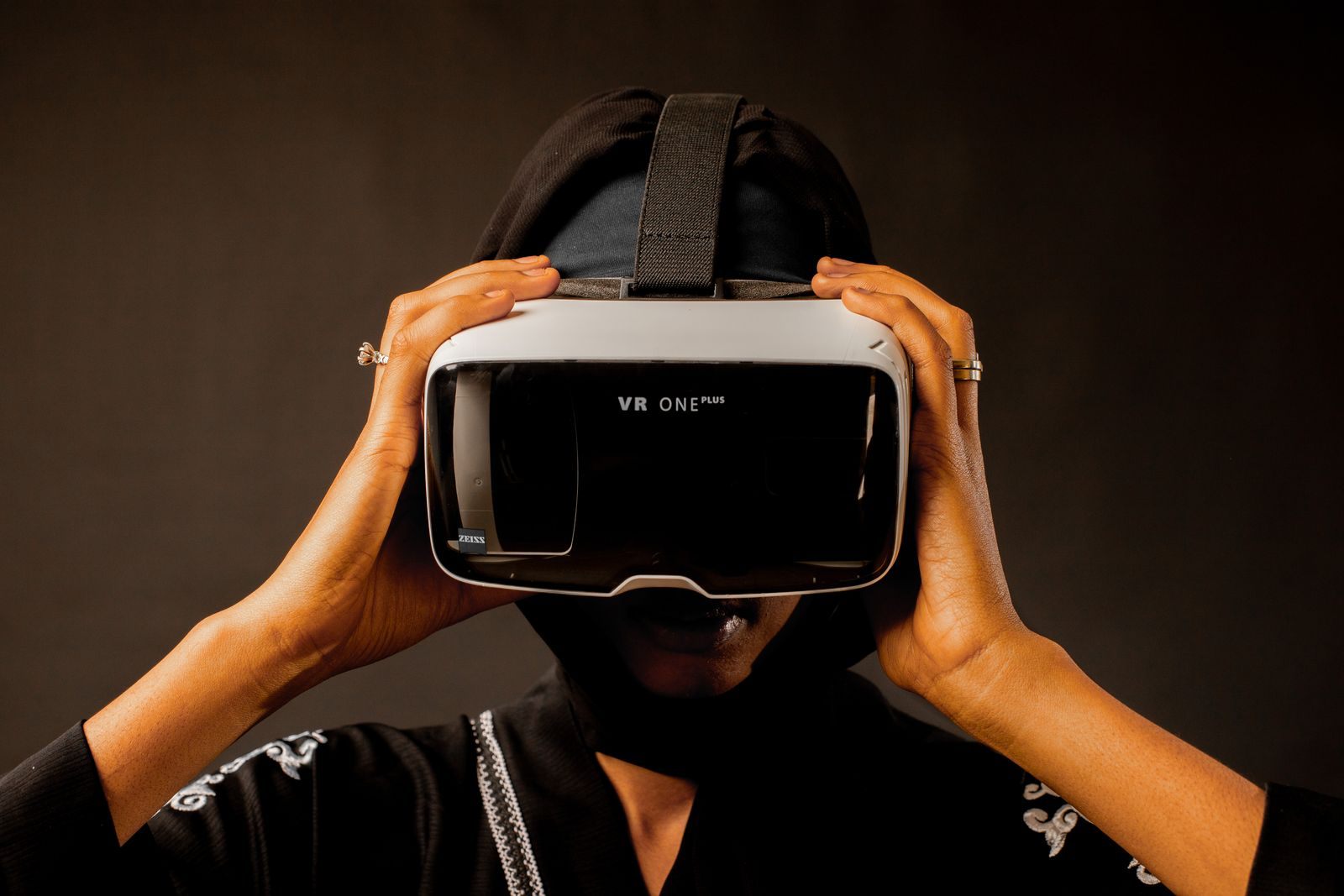 A person holding a VR headset to their eyes, one way to take a cruise ship 360 virtual tour