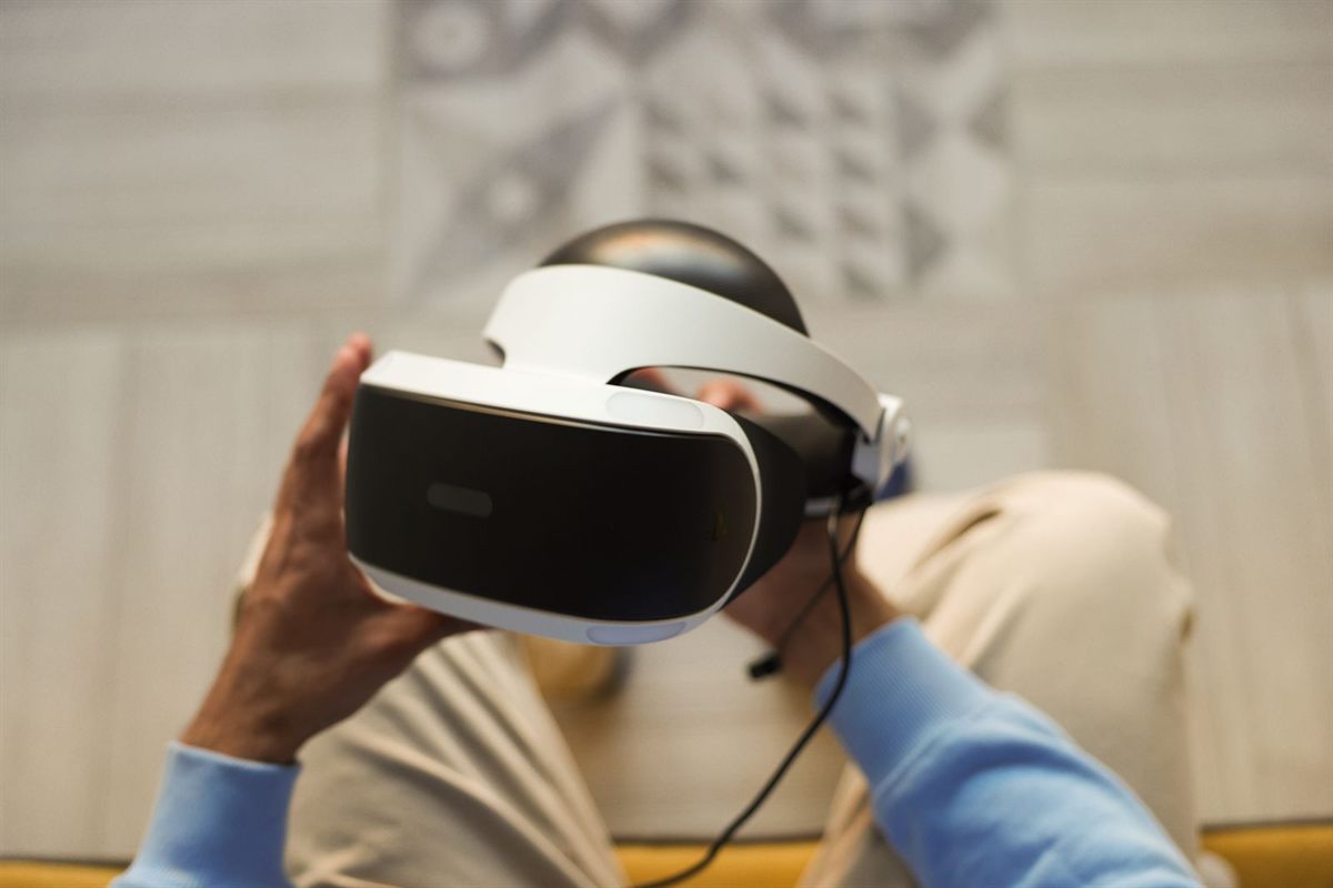 Hands holding a virtual reality headset